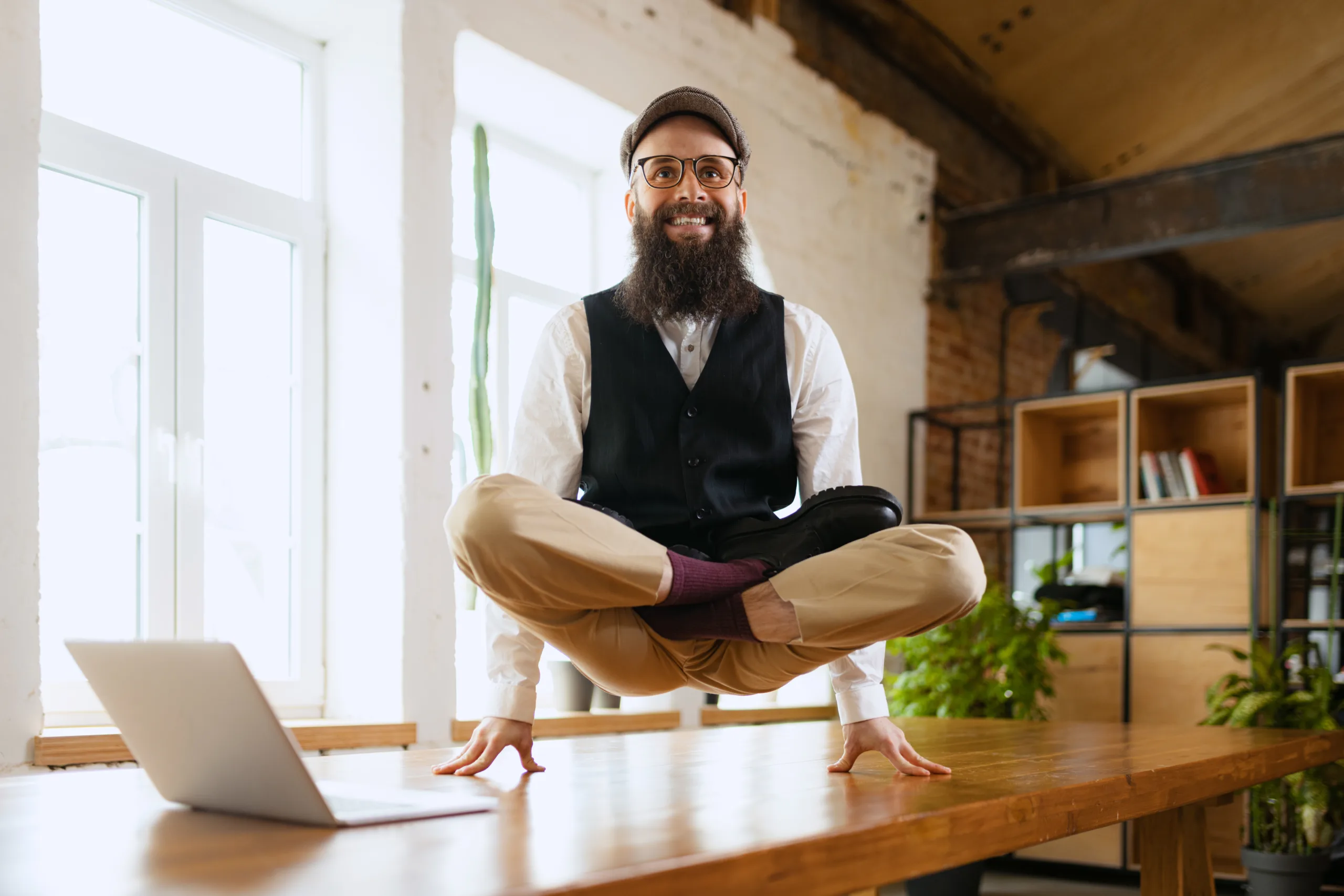 Businessman, cheerful employee standing at yoga pose at office, on working table, meditating after work,Self-Care Business